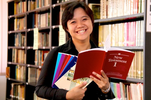 Shyron receiving her textbooks for the Moore Theological College's ThC.